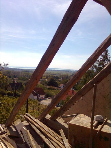 View of Lake Balaton through the roof rafters after tiles were removed.