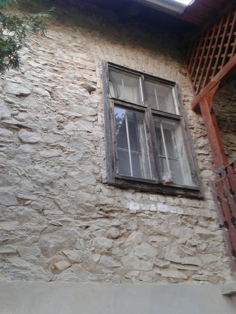 The old window still in the wall after external plaster was removed.