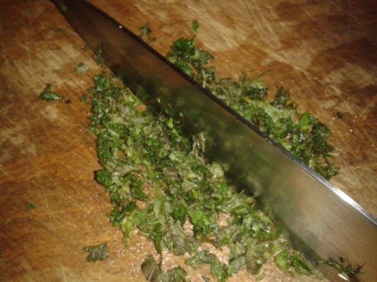 Chop the nettle with a large knife, using a rocking motion to avoid touching the plant.
