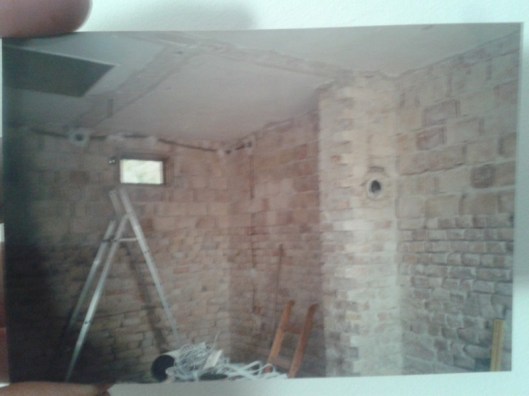 Old printed photo showing early work on our house renovation.