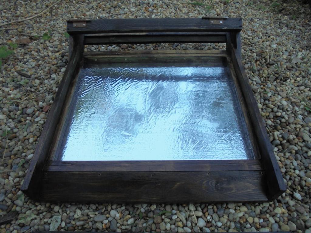 Solar dryer preheater frame showing reflective foil covered insulated base insert.